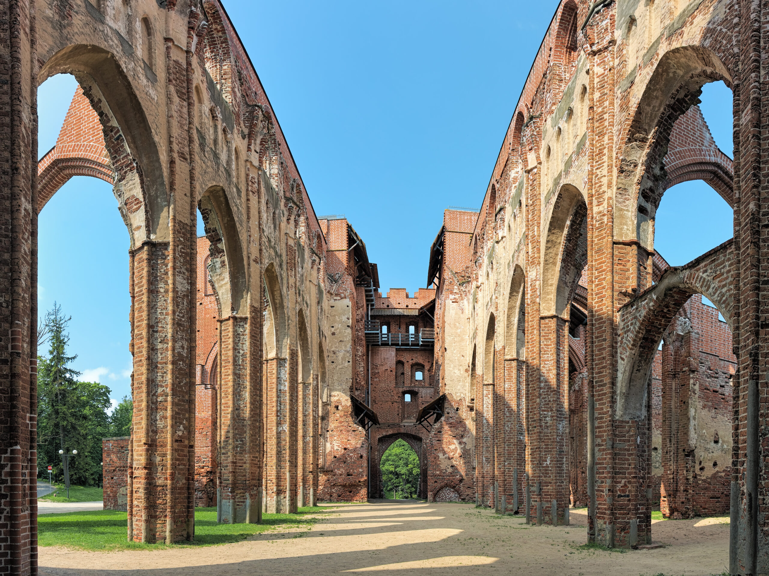 Tartu Cathedral ruins with Gothic brick arches open to blue sky, Tartu Estonia — the Baltics