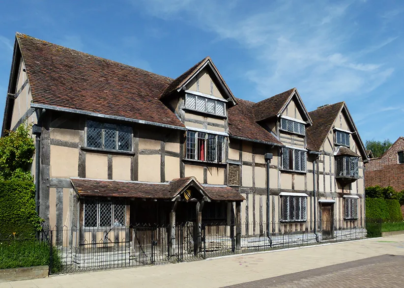Shakespeare's Birthplace, a half-timbered Tudor house with leaded windows and dark oak beams on a sunny day in Stratford-upon-Avon, England